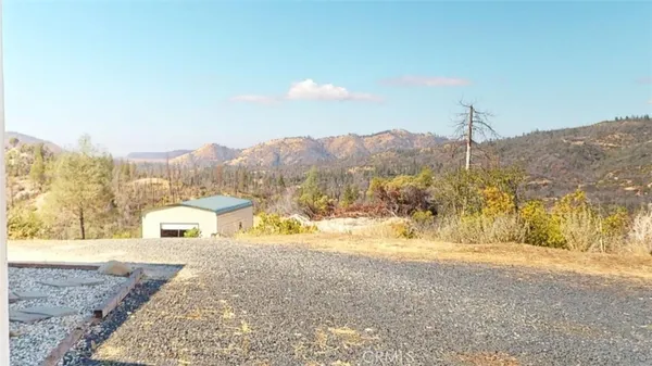 a view of a livingroom with dining area a chandelier and wooden floor