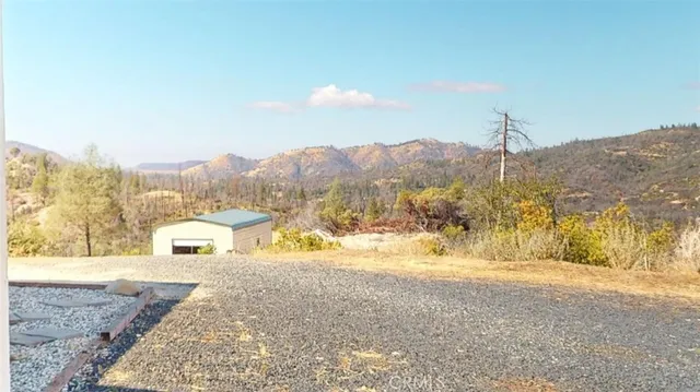 a view of a livingroom with dining area a chandelier and wooden floor