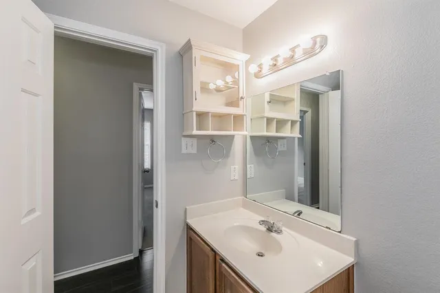 a bathroom with a sink a mirror and shower