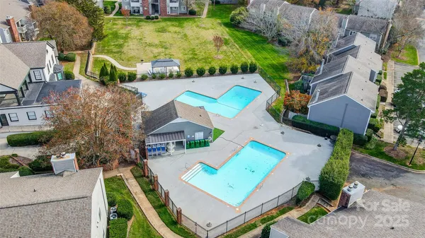 an aerial view of a house with swimming pool and porch
