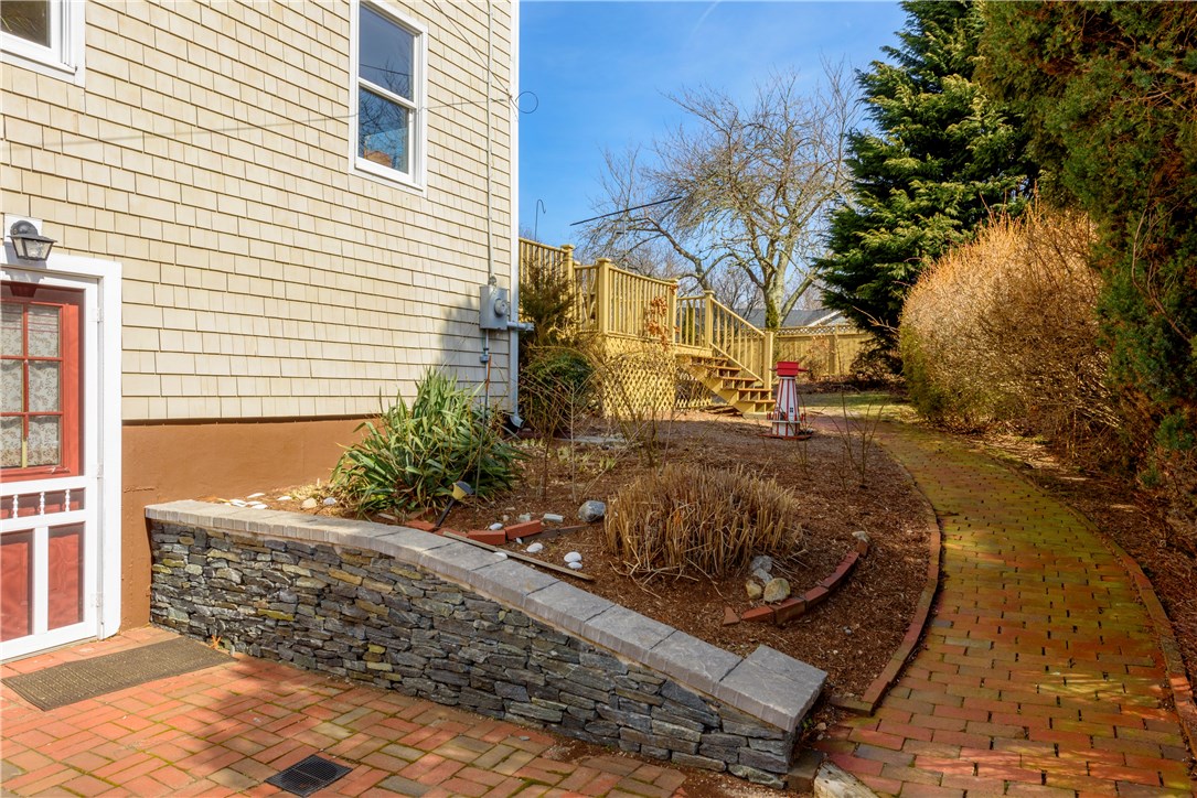 17 Beach Plum Road Narragansett, RI 02882 - Photo 19 of 20 Brick patio with access to the lower level and the back yard.