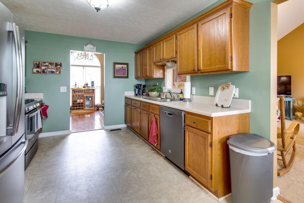 392 Cedar Grove Road Lebanon, TN 37087 - Photo 11 of 28 a kitchen with a sink stove and cabinets