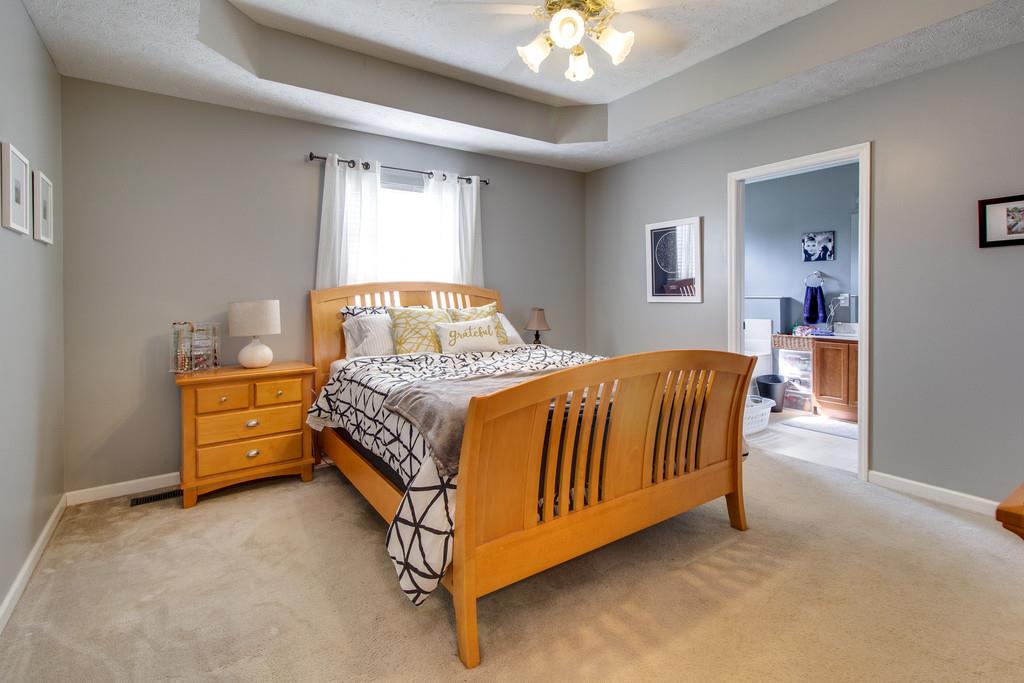 392 Cedar Grove Road Lebanon, TN 37087 - Photo 12 of 28 a bedroom with a bed and a chandelier