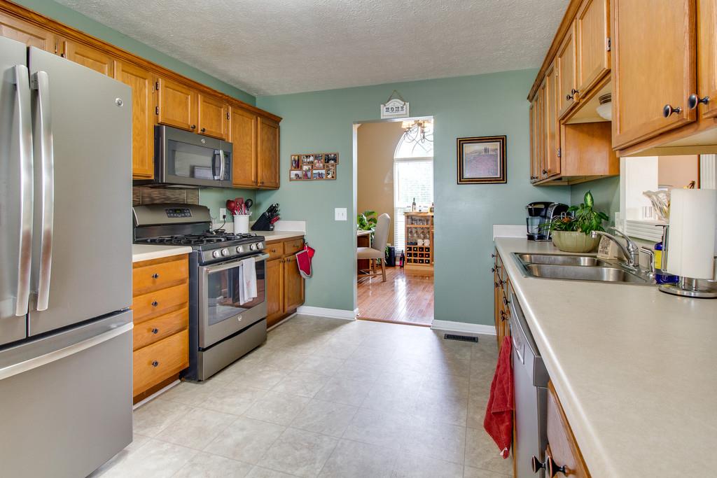 392 Cedar Grove Road Lebanon, TN 37087 - Photo 10 of 28 a kitchen with stainless steel appliances a stove top oven a sink a dining table and chairs