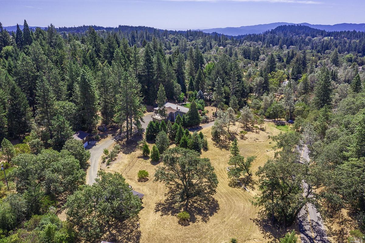 620 White Cottage Road North Angwin, CA 94508 - Photo 1 of 1 Aerial shot of whole 6.7 acre property with Main house, attached in-law unit, detached 4-car garage with living space above and 1200 sqft. detached legal guest house with 2BD, 1BA and deck overlooking the Cabernet hobby vineyard and fruit trees..