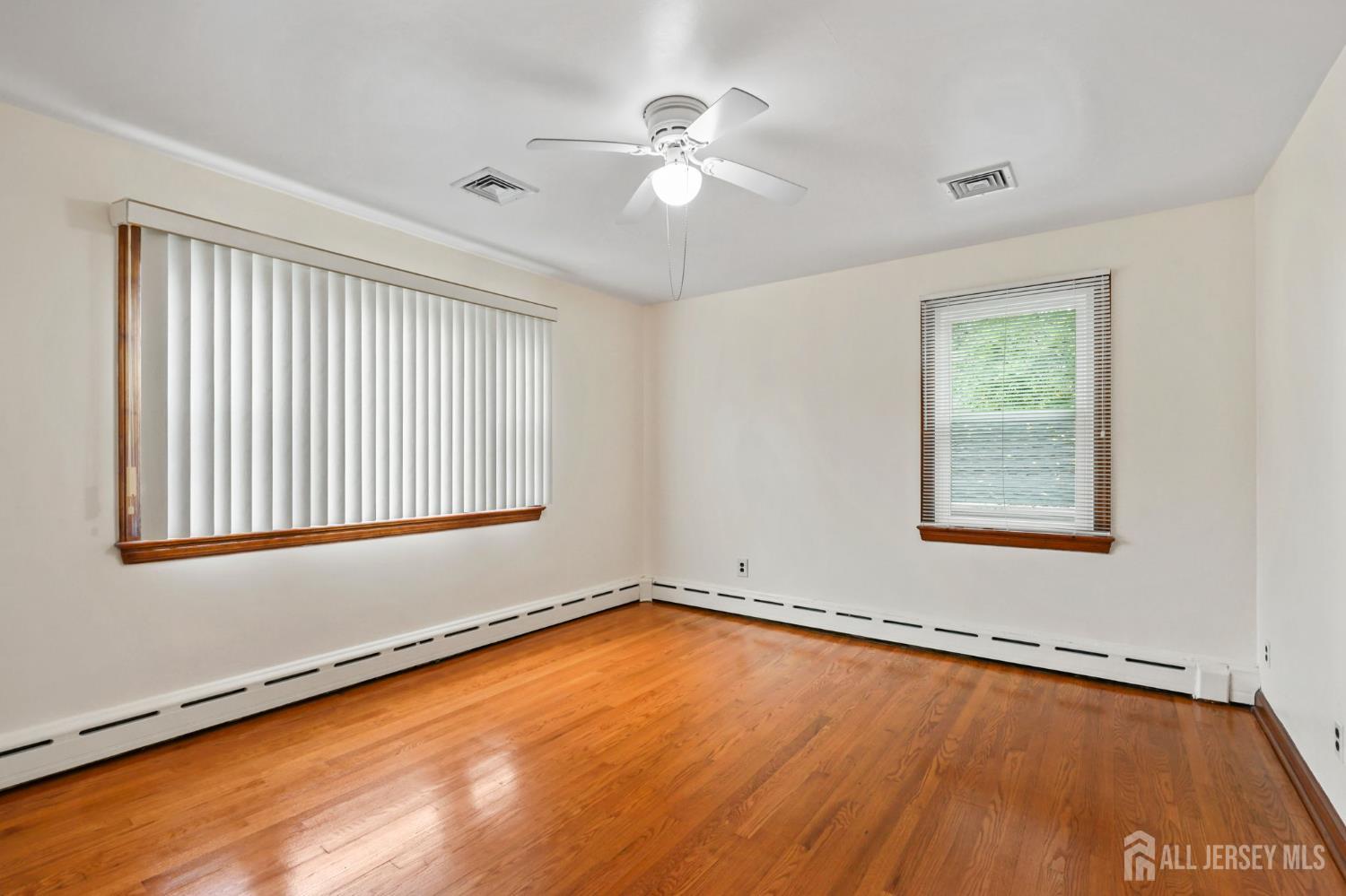 21 Reed Street Edison, NJ 08817 - Photo 12 of 27 a view of an empty room with a window and wooden floor