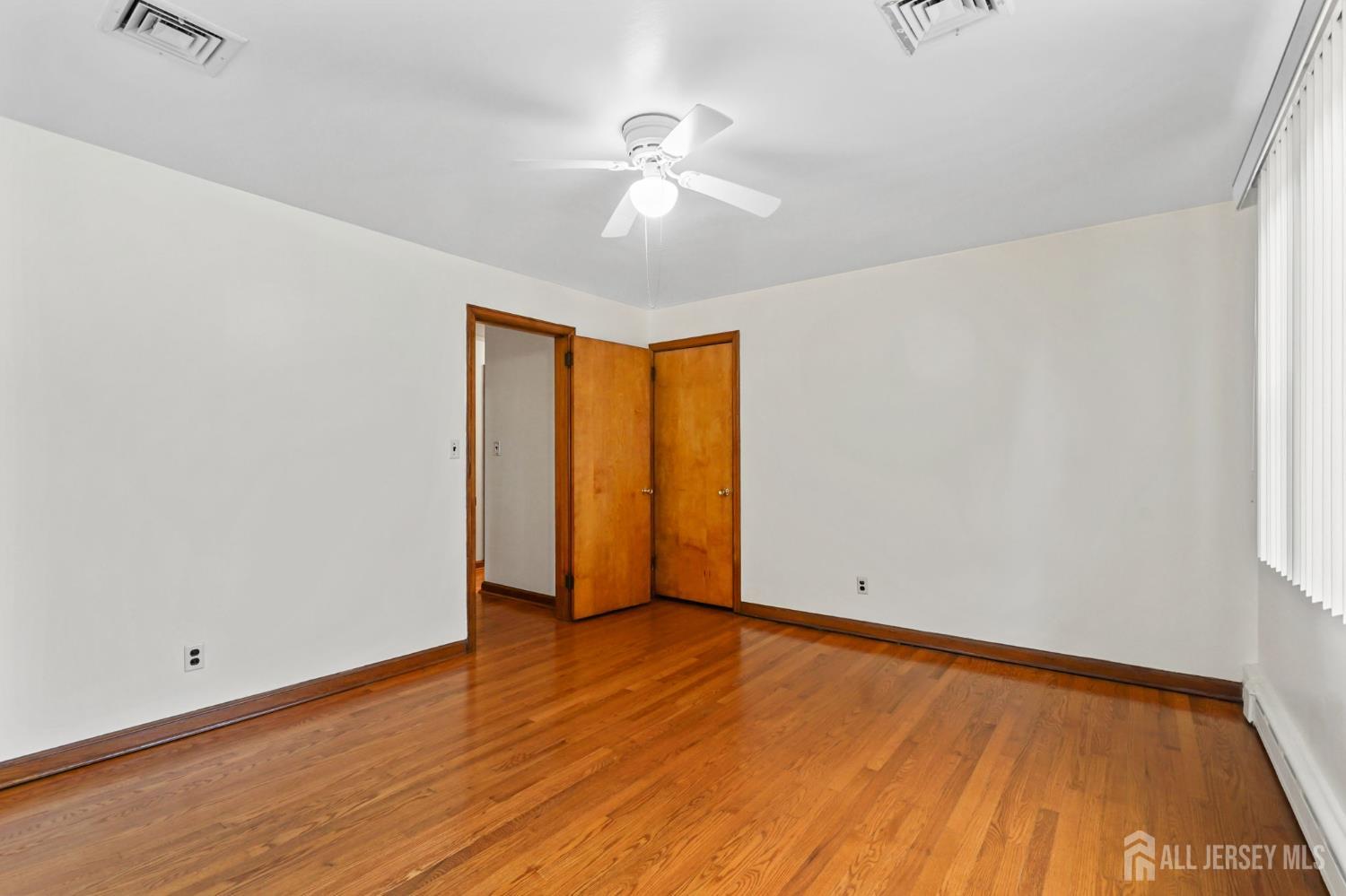 21 Reed Street Edison, NJ 08817 - Photo 13 of 27 an empty room with wooden floor and windows