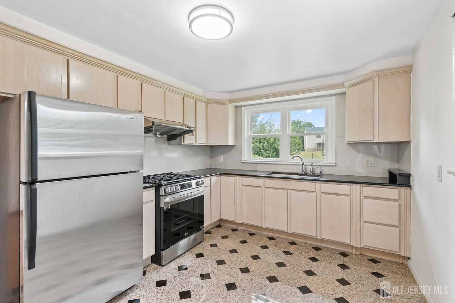 21 Reed Street Edison, NJ 08817 - Photo 16 of 27 a kitchen with granite countertop a refrigerator sink and microwave