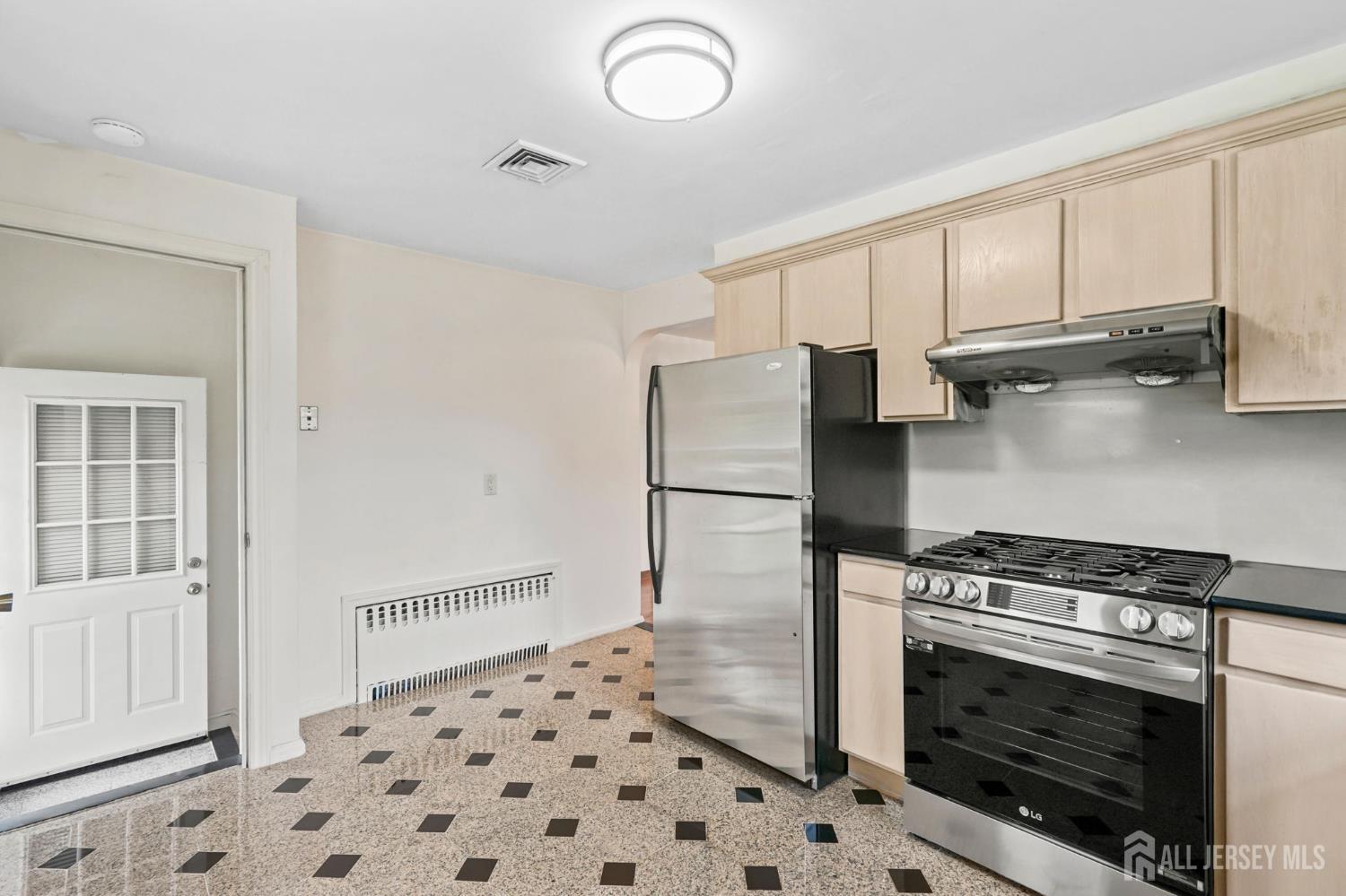 21 Reed Street Edison, NJ 08817 - Photo 17 of 27 a kitchen with granite countertop a stove and a refrigerator