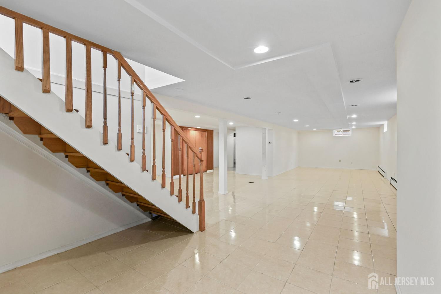 21 Reed Street Edison, NJ 08817 - Photo 21 of 27 a view of staircase with lots of frames on wall and a window
