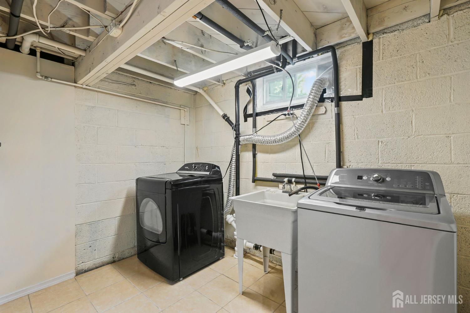 21 Reed Street Edison, NJ 08817 - Photo 22 of 27 a utility room with dryer and washer