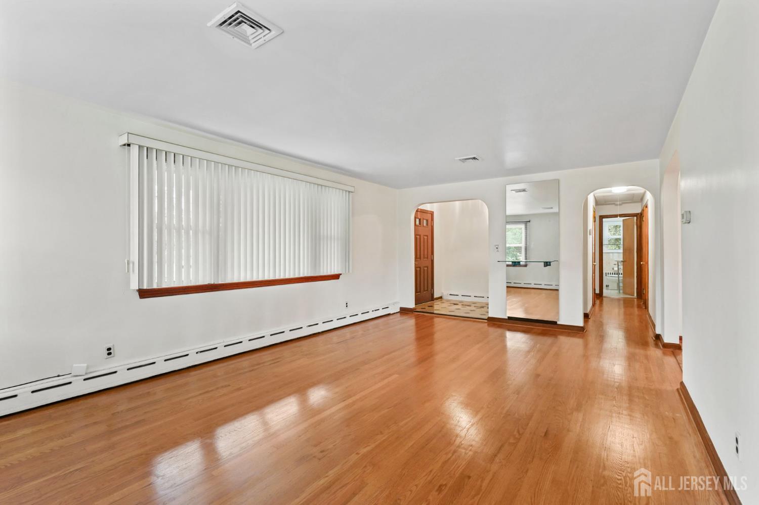 21 Reed Street Edison, NJ 08817 - Photo 6 of 27 a view of an empty room with wooden floor and a window
