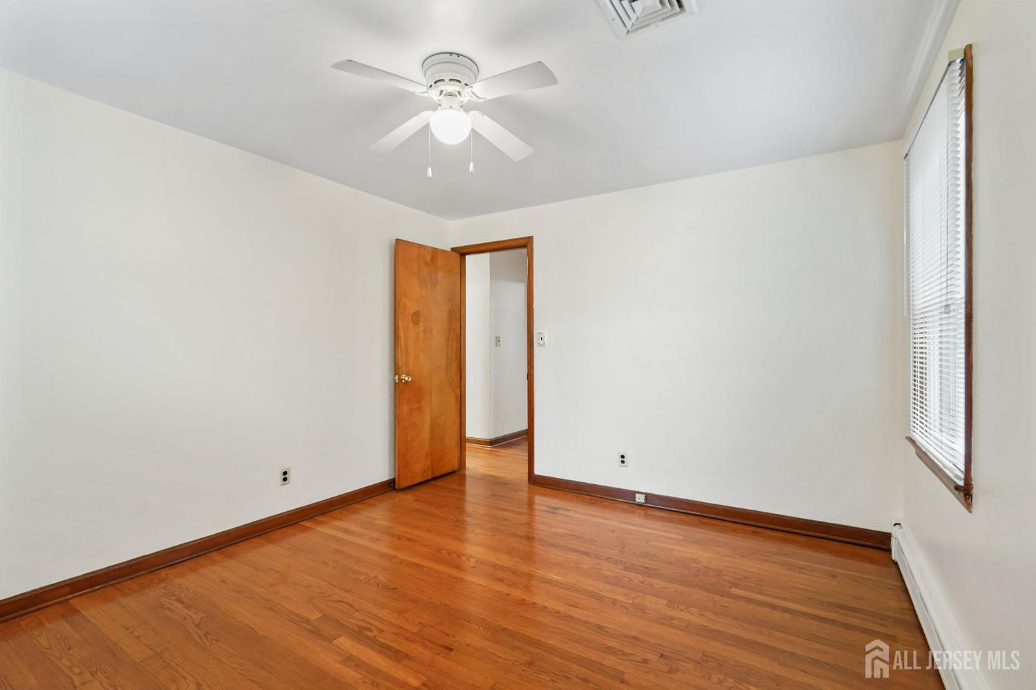 21 Reed Street Edison, NJ 08817 - Photo 10 of 27 an empty room with wooden floor and window
