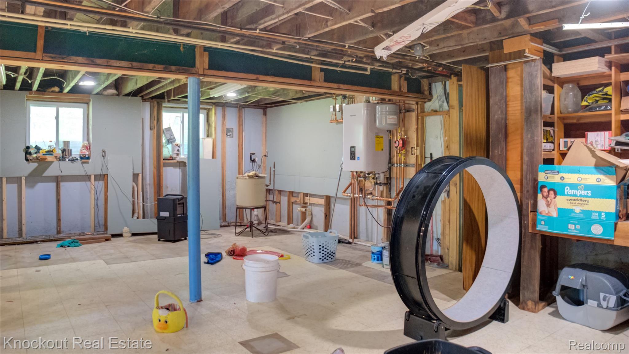 4195 Williamson Road Saginaw, MI 48601 - Photo 28 of 50 Unfinished basement with exposed ceiling joists, framed walls, and two windows providing natural light