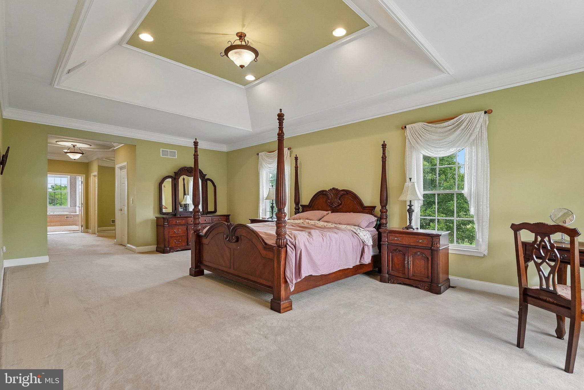 1 Baker Way Pennington, NJ 08534 - Photo 31 of 77 a spacious bedroom with a bed and a chandelier