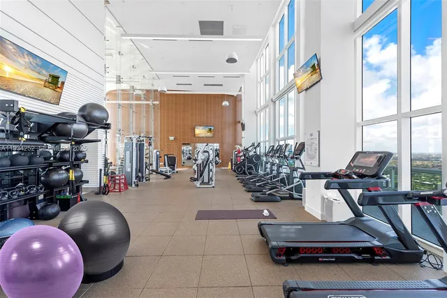 a room with gym equipment and a flat screen tv
