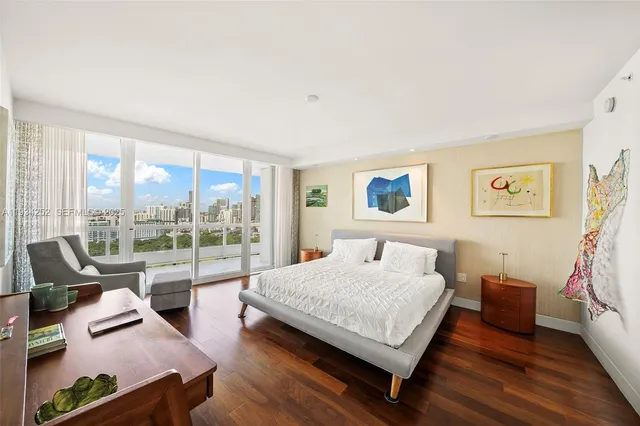 a bedroom with a bed and glass walk in closet