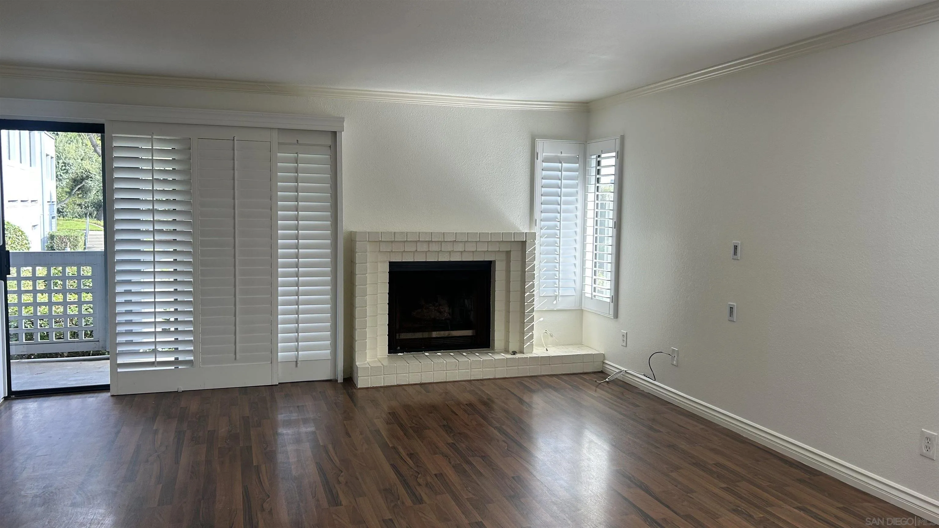 928 Intrepid Court Del Mar, CA 92014 - Photo 6 of 21 an empty room with wooden floor and fireplace