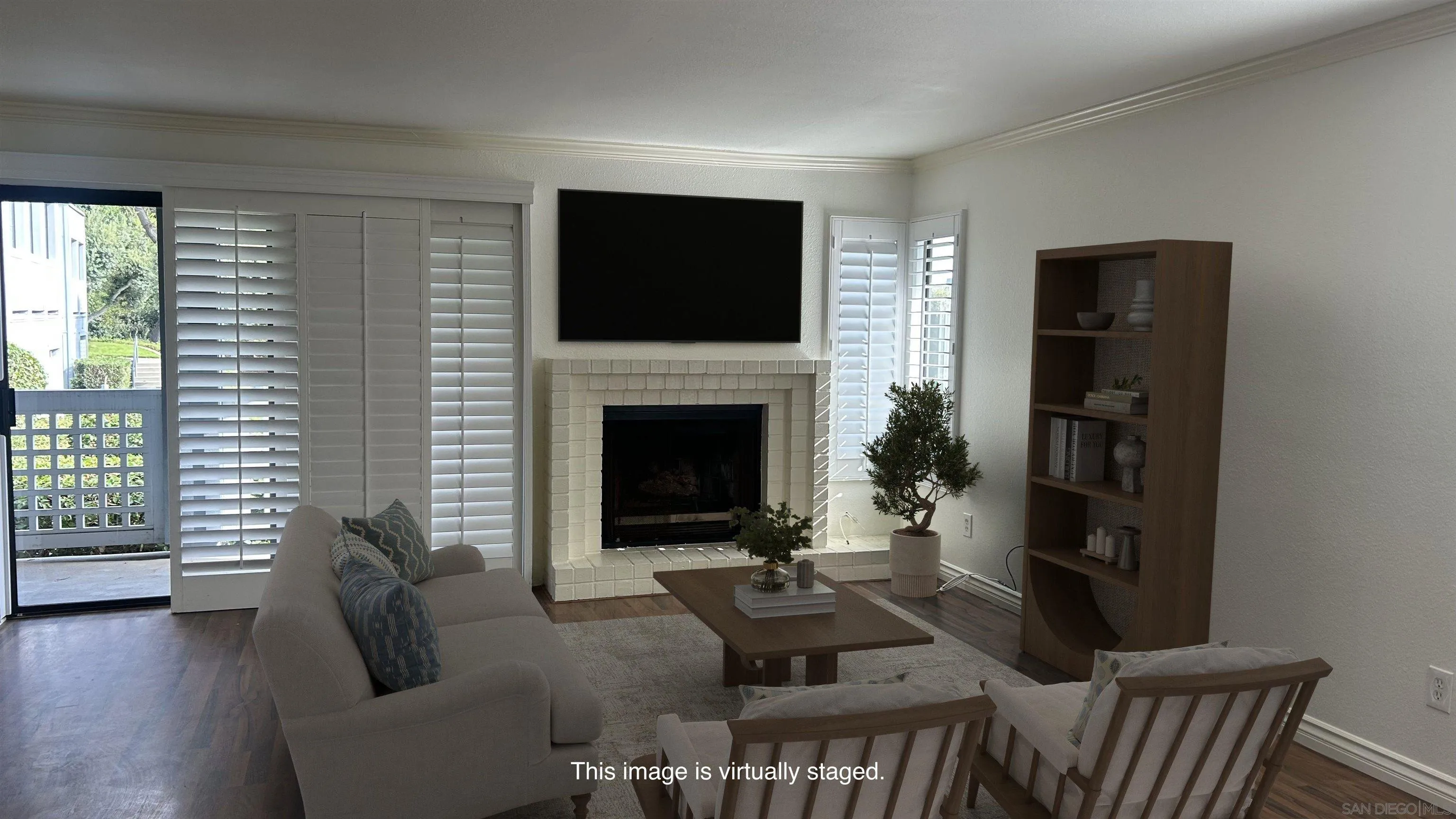 928 Intrepid Court Del Mar, CA 92014 - Photo 7 of 27 a living room with furniture a flat screen tv and a fireplace