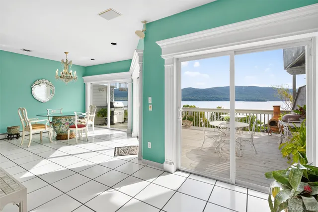 a living room with furniture and a dining table with chairs