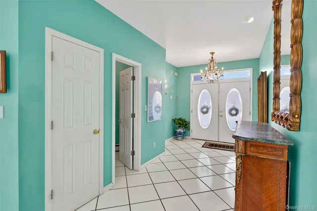 a bedroom with a bed chandelier and a couch