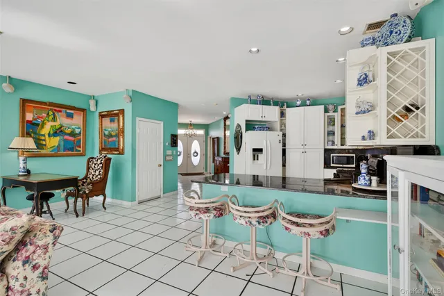 a bedroom with a bed a large window and furniture