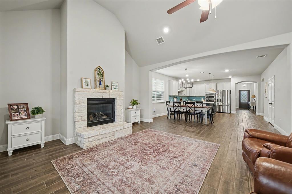 433 Forestridge Drive Fate, TX 75087 - Photo 11 of 38 a living room with furniture and a fireplace