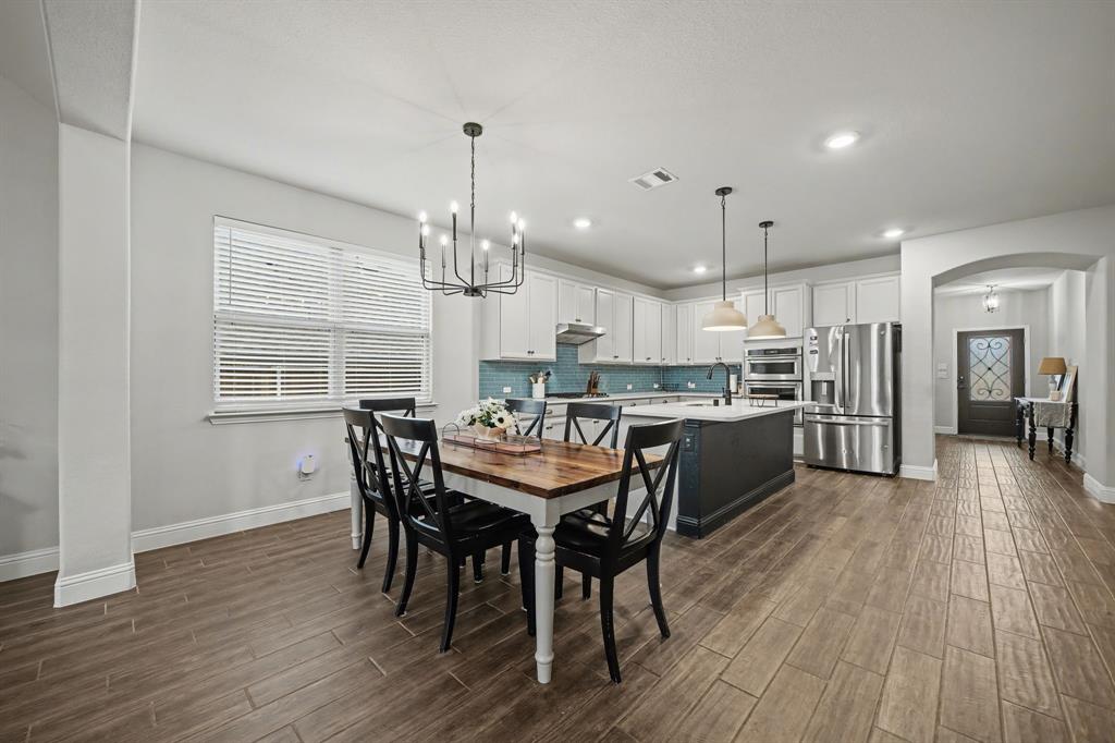 433 Forestridge Drive Fate, TX 75087 - Photo 12 of 38 a view of a dining room with furniture window and wooden floor