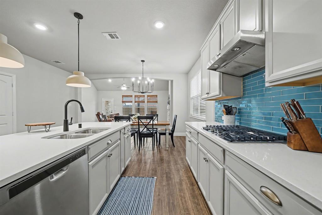 433 Forestridge Drive Fate, TX 75087 - Photo 15 of 38 a kitchen with stainless steel appliances granite countertop a sink stove and cabinets