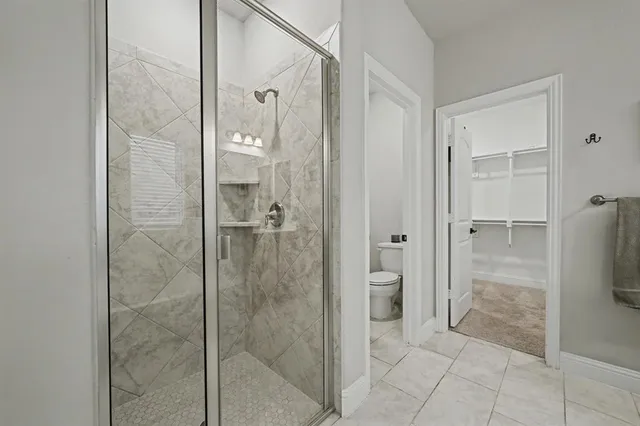 a bathroom with a shower and a mirror