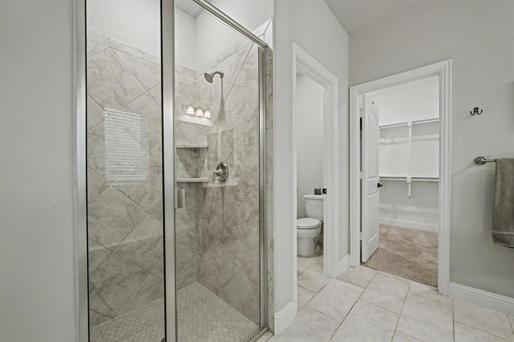 433 Forestridge Drive Fate, TX 75087 - Photo 21 of 38 a bathroom with a shower and a mirror