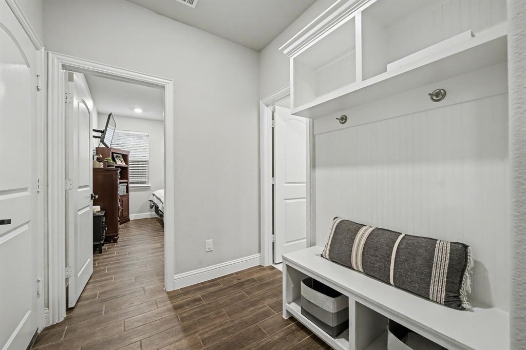 433 Forestridge Drive Fate, TX 75087 - Photo 23 of 38 a view of a hallway with wooden floor and staircase