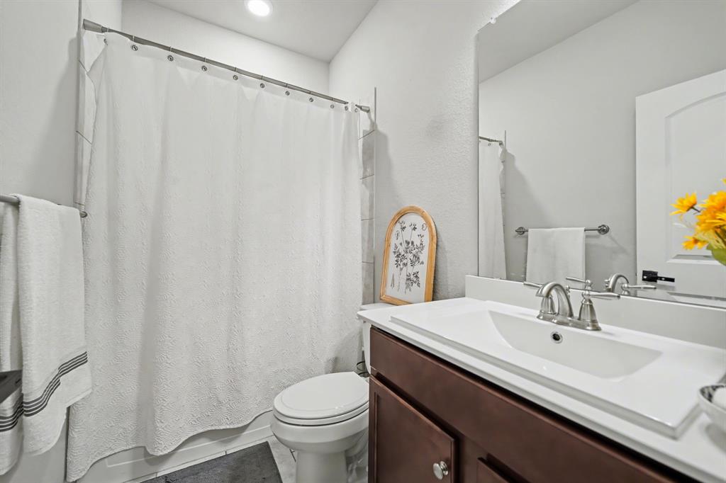 433 Forestridge Drive Fate, TX 75087 - Photo 25 of 38 a bathroom with a sink and a mirror