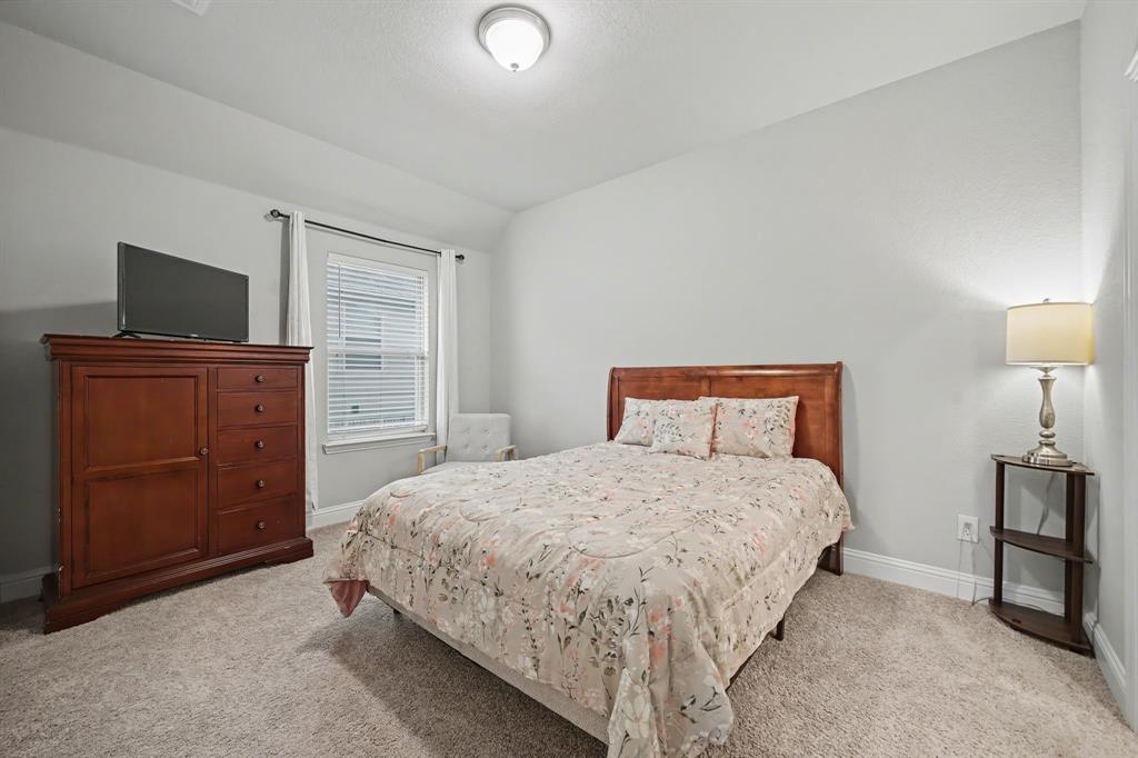 433 Forestridge Drive Fate, TX 75087 - Photo 28 of 38 a bedroom with a bed and furniture