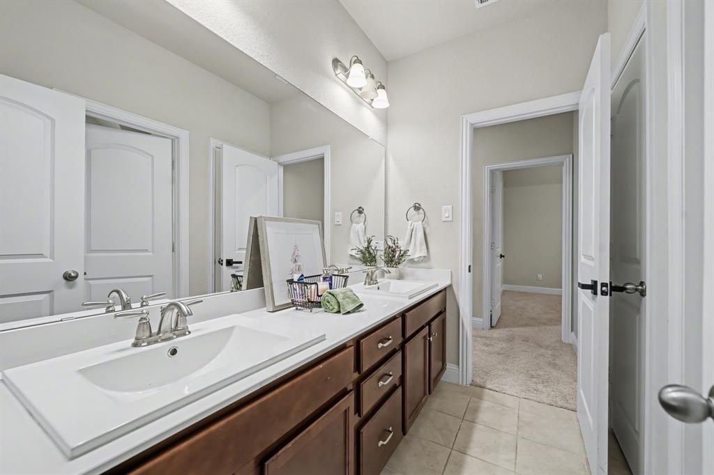 433 Forestridge Drive Fate, TX 75087 - Photo 31 of 38 a bathroom with a sink double vanity and a mirror
