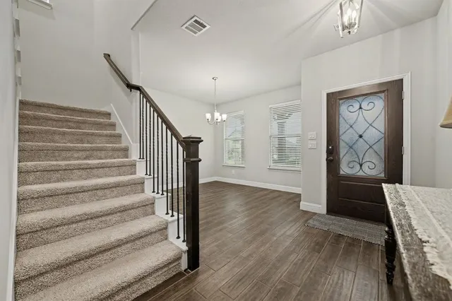 a view of an entryway with wooden floor
