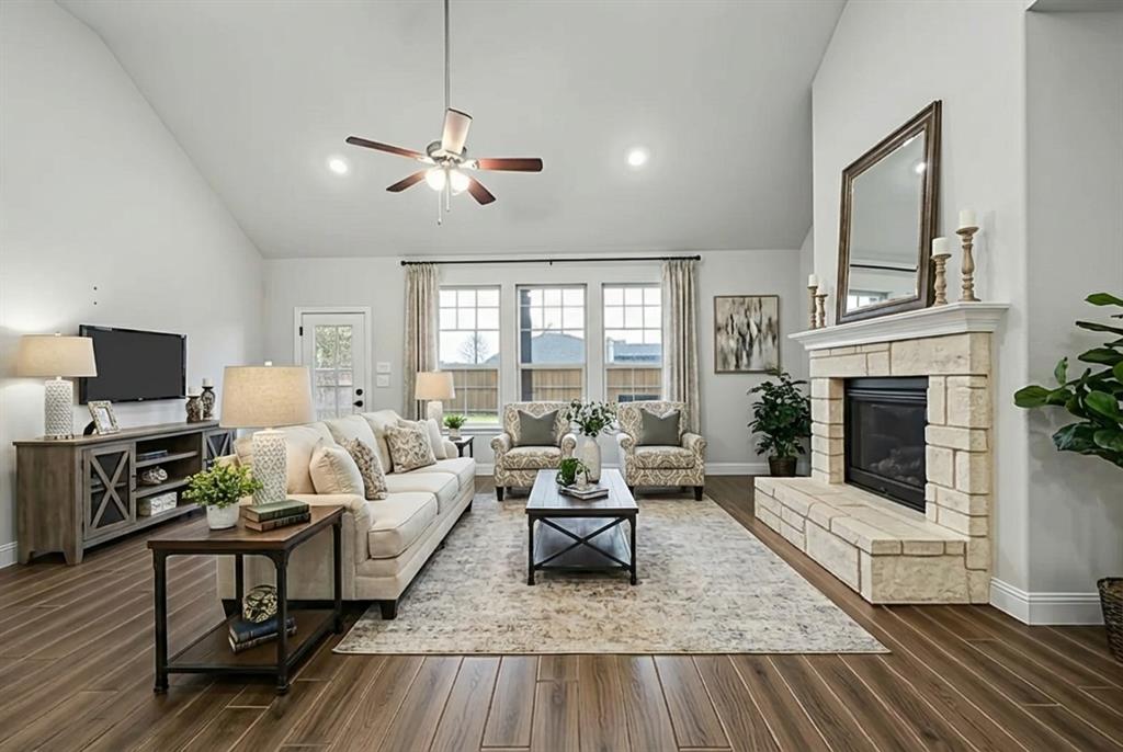 433 Forestridge Drive Fate, TX 75087 - Photo 9 of 38 a living room with furniture and a fireplace