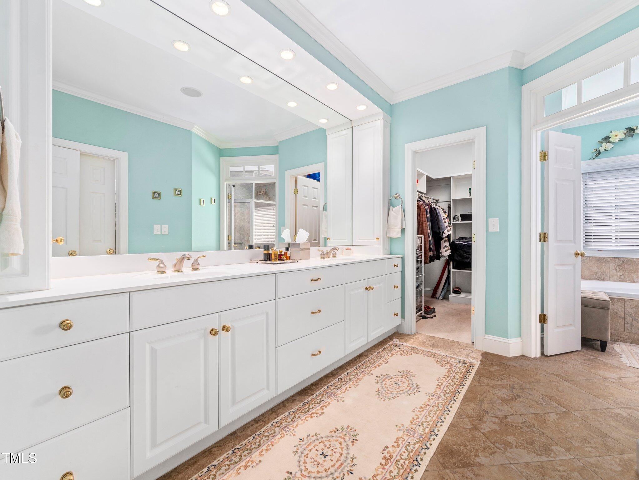 10937 Cahill Road Raleigh, NC 27614 - Photo 31 of 53 Dressing Rm of Primary Bath has Mirrored Vanity, 2 Sinks + 2 Sep Closets w/Auto Lighting