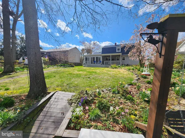 a backyard of a house with yard and outdoor seating