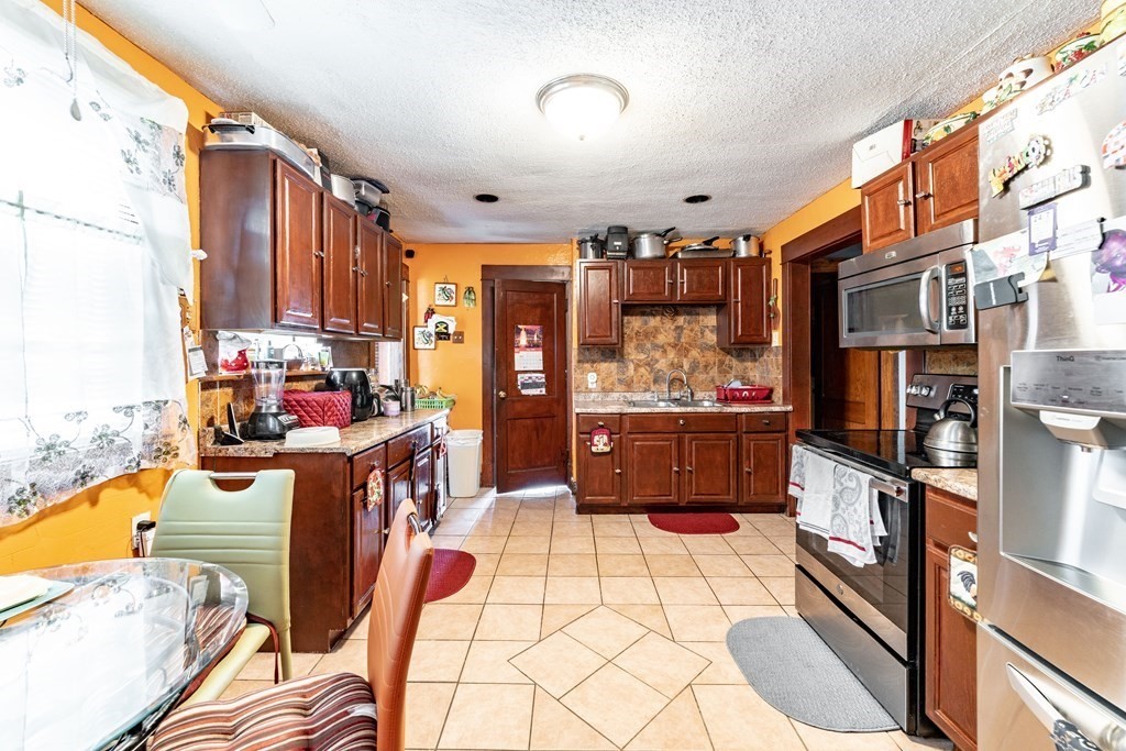 123 Wilber Street Springfield, MA 01104 - Photo 11 of 27 a view of a kitchen with furniture and large window