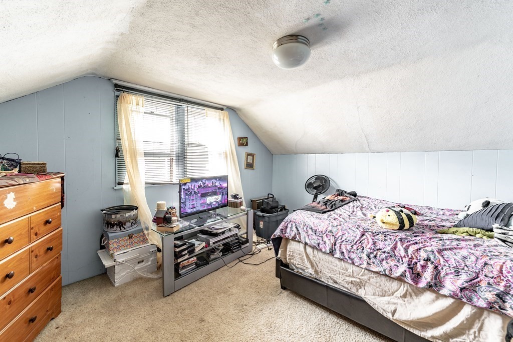 123 Wilber Street Springfield, MA 01104 - Photo 14 of 27 a bedroom with a bed dresser and a window