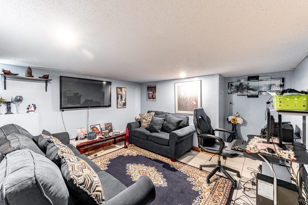 123 Wilber Street Springfield, MA 01104 - Photo 21 of 27 a living room with furniture and a flat screen tv
