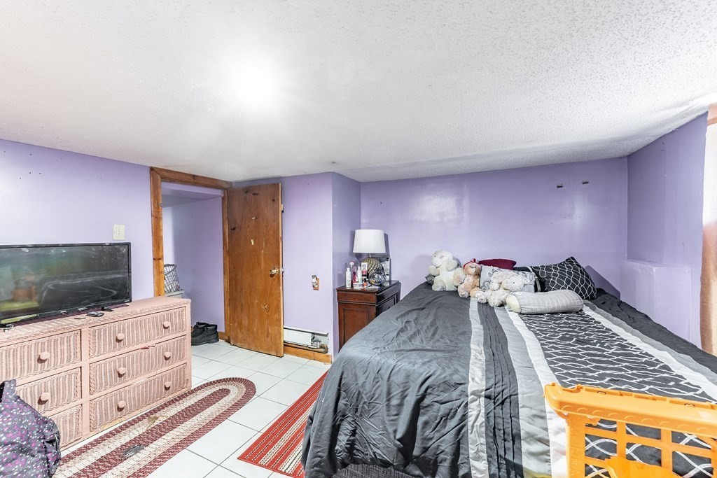 123 Wilber Street Springfield, MA 01104 - Photo 25 of 27 a bedroom with a bed and flat screen tv