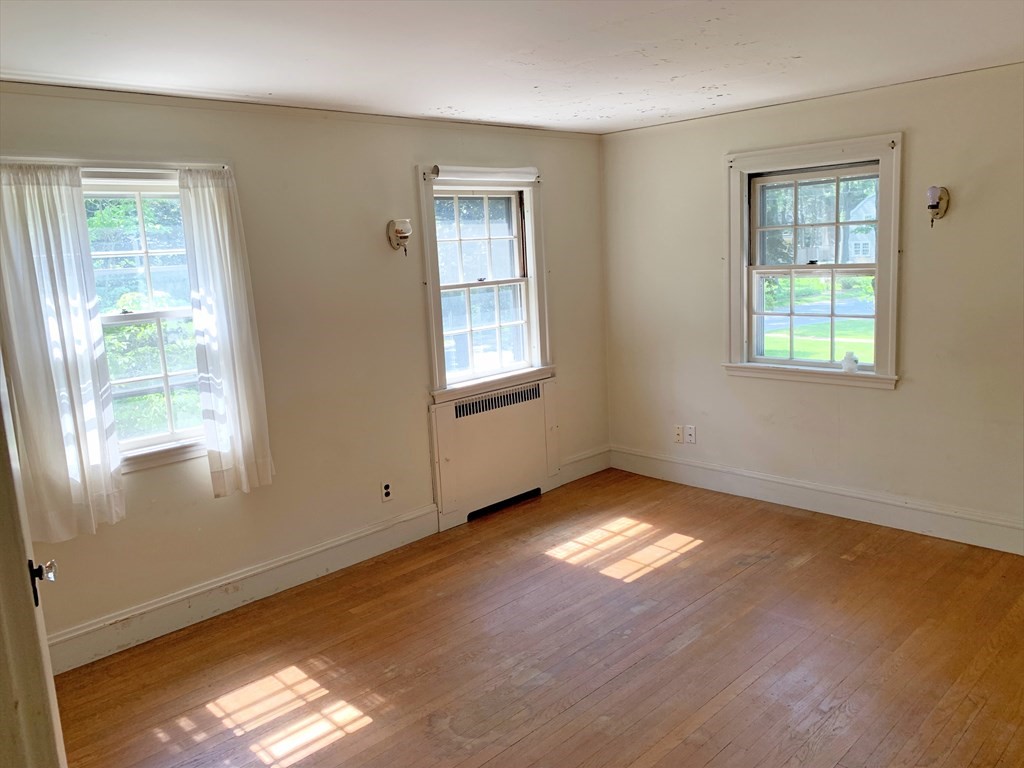 78 Whittier Road Wellesley, MA 02481 - Photo 21 of 27 a view of an empty room with wooden floor and a window