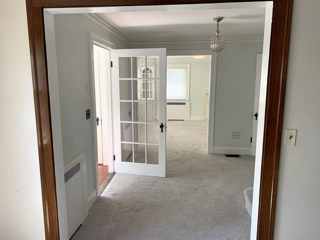 78 Whittier Road Wellesley, MA 02481 - Photo 8 of 27 a view of a hallway with wooden shelves