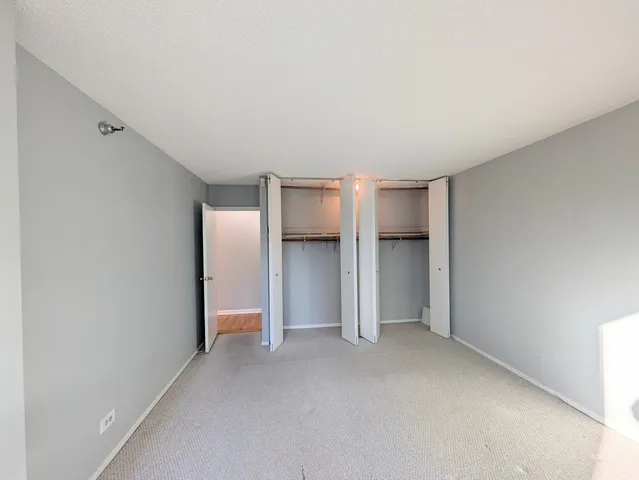 a view of an empty room with a closet