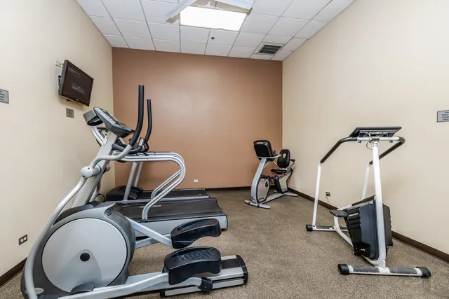 a room with gym equipment and a mirror