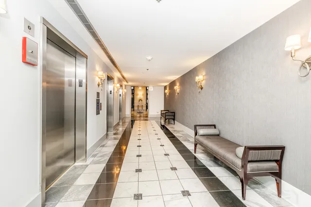 a bathroom with mirror and shower