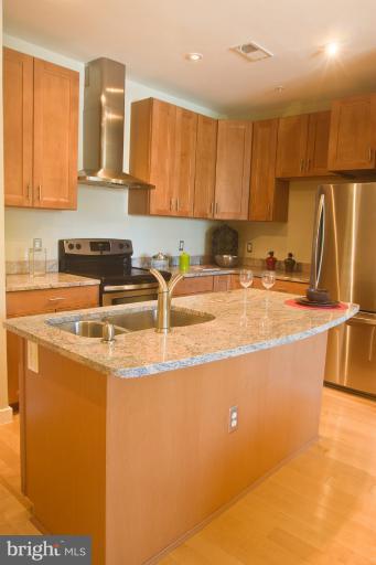 1917 2nd Street Northeast, Unit 201 Washington, DC 20002 - Photo 1 of 23 a kitchen with stainless steel appliances granite countertop a sink a stove and a refrigerator