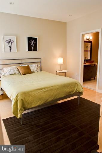 1917 2nd Street Northeast, Unit 201 Washington, DC 20002 - Photo 2 of 23 a bedroom with a bed and wooden floor